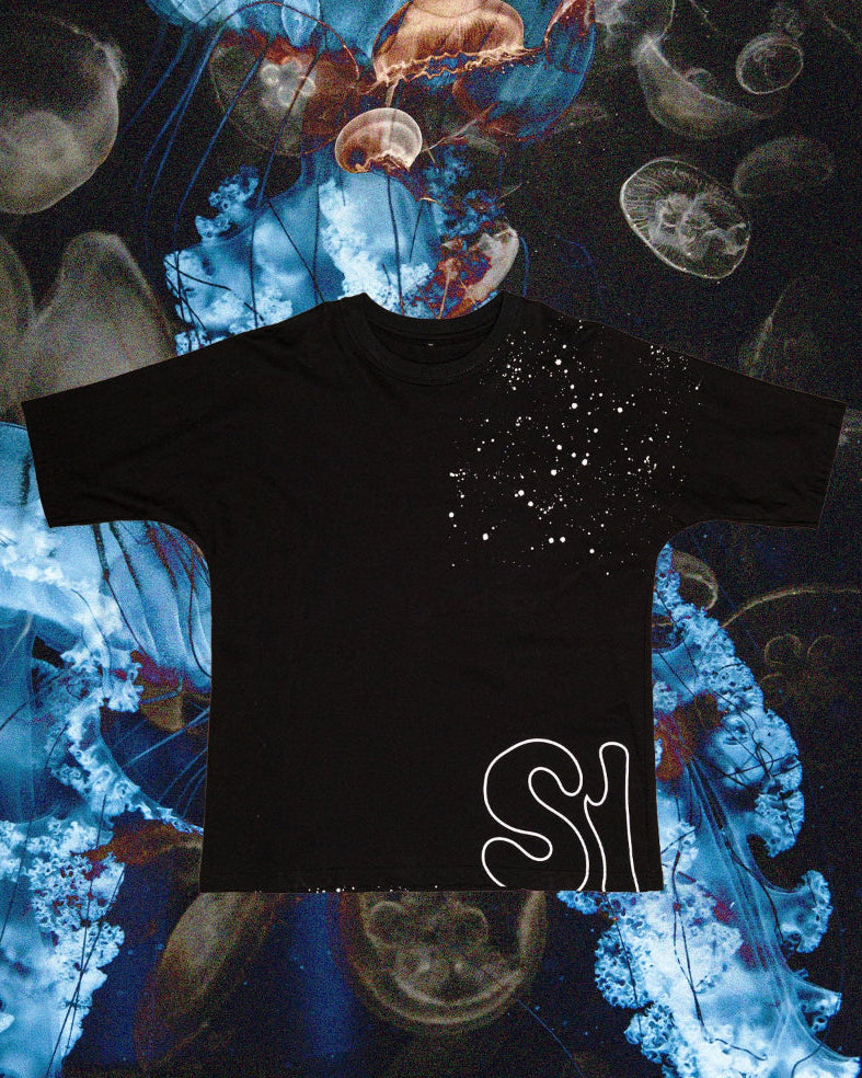 Black t-shirt with a design on a colorful abstract background