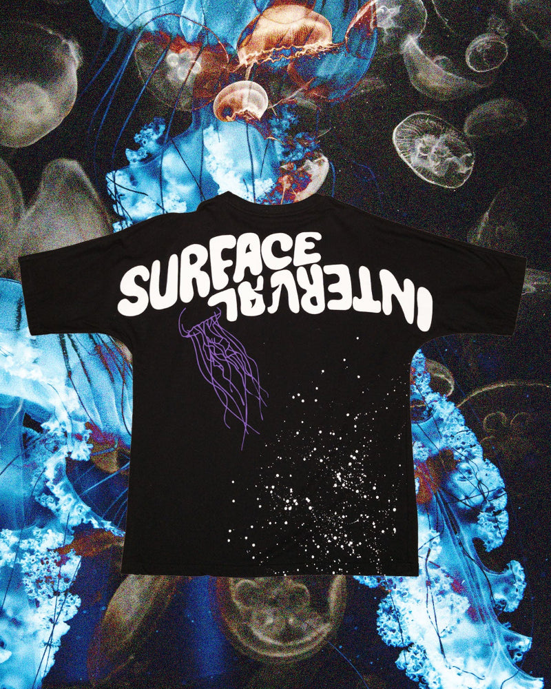 Black t-shirt with 'SURFACE INTERVAL' text on a jellyfish-themed background