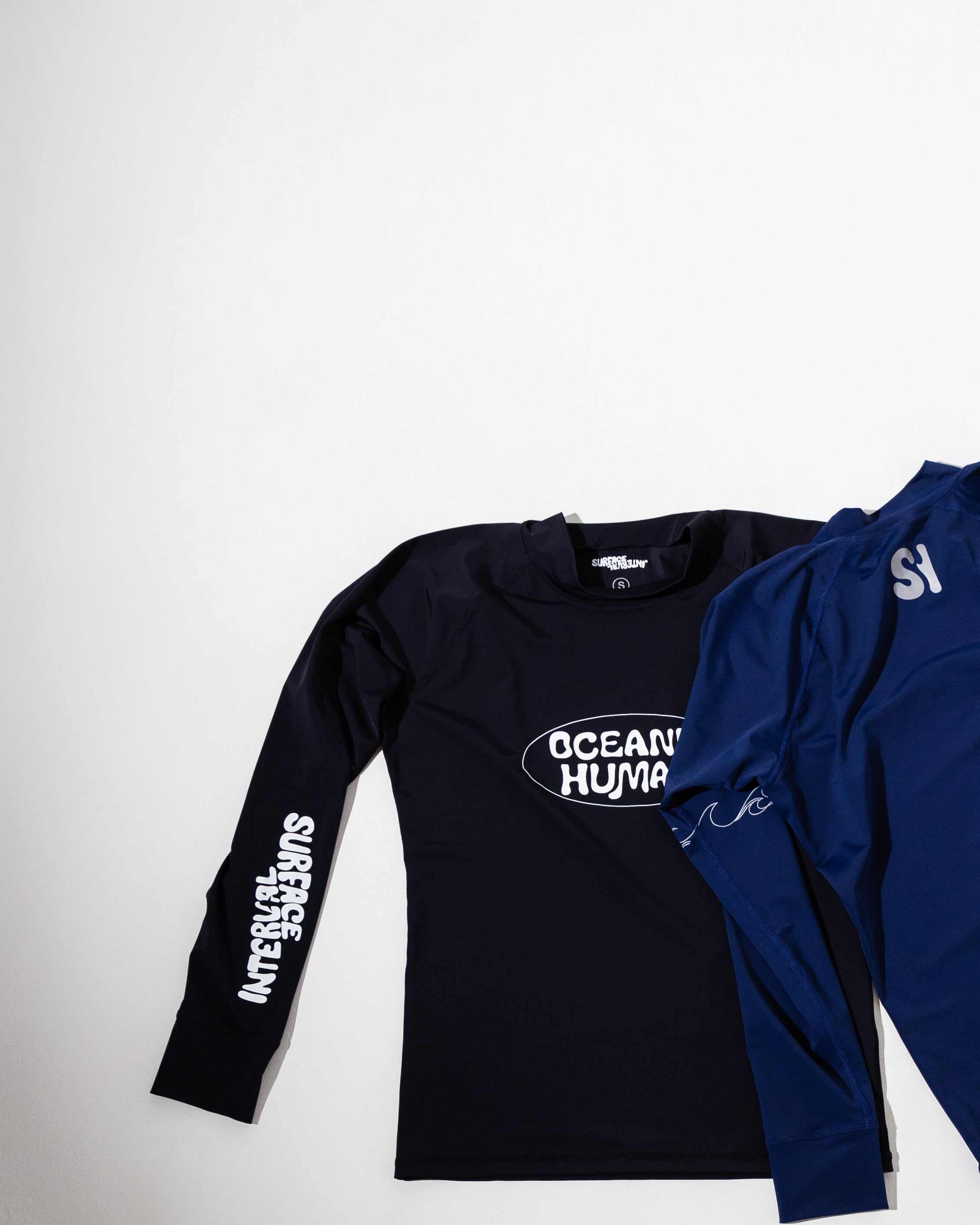 'Oceanic Human' RashguardFor the Ocean, From the Ocean
Our rashguards are a tribute to the ocean's beauty and resilience. Crafted from single-use plastics, ghost nets, and recycled ocean was'Oceanic Human' RashguardSurface Interval
